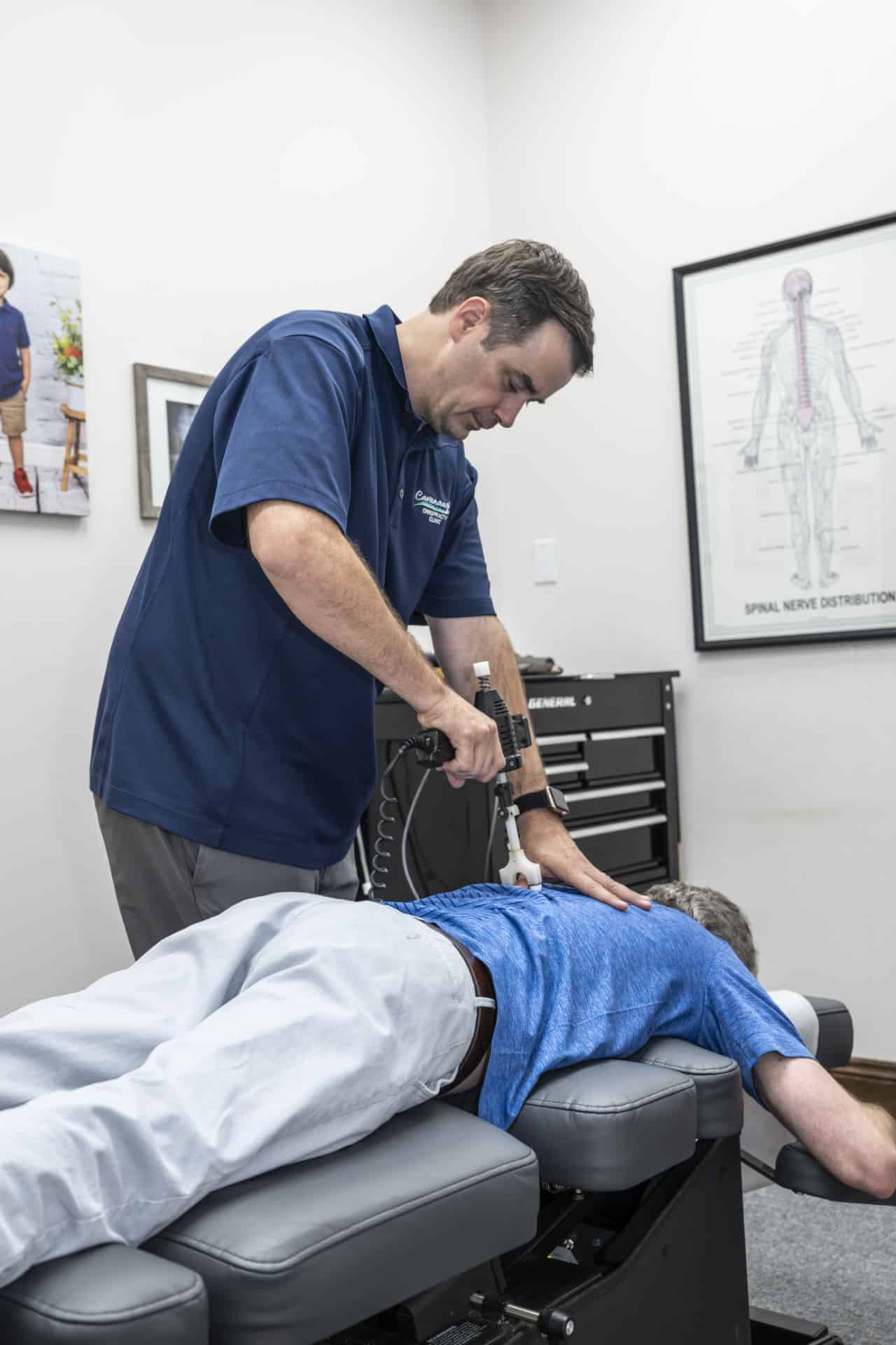 Chiropractor in Lafayette, LA performing low force adjustment with ArthroStim instrument