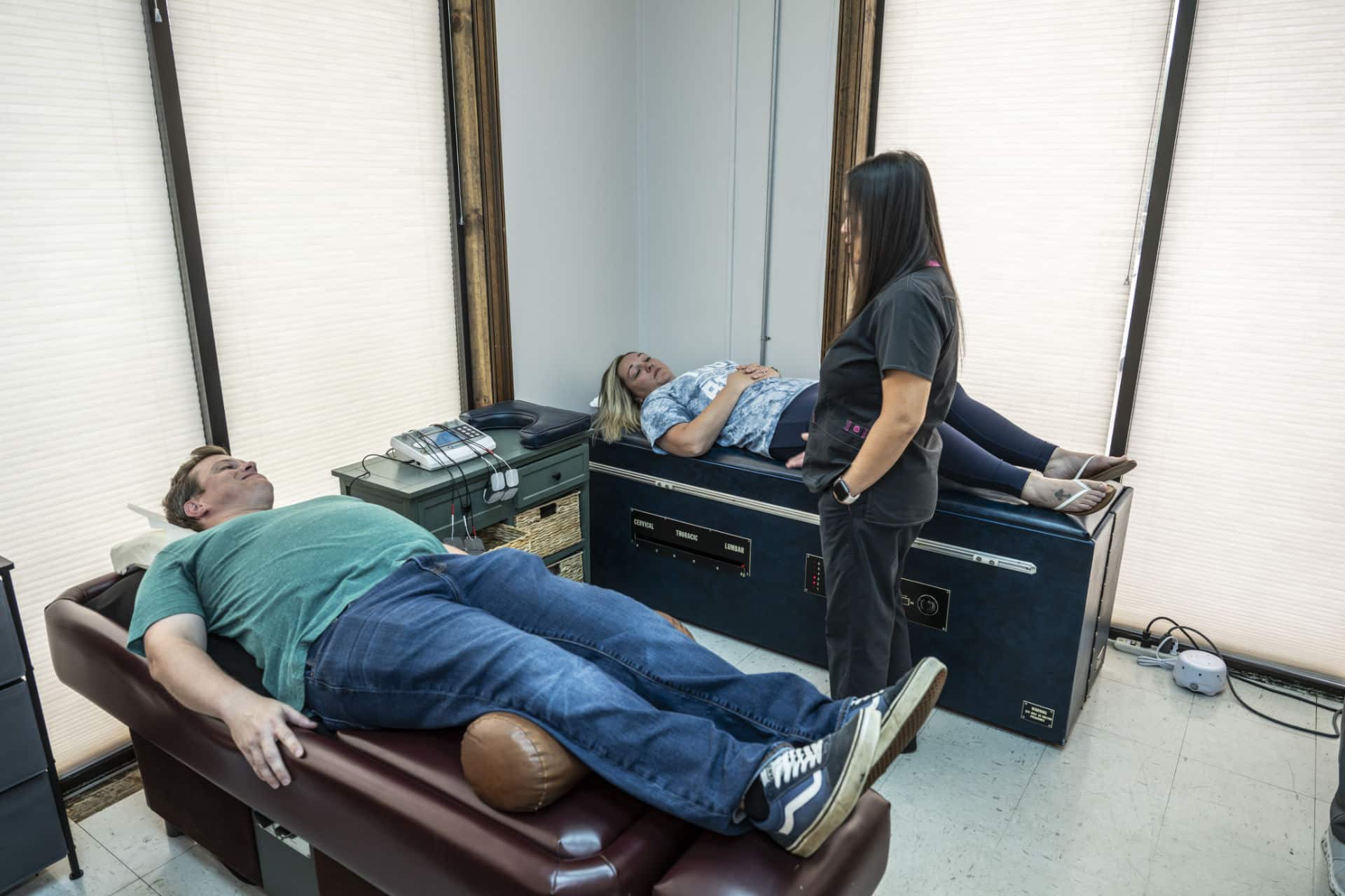 Patients receiving intersegmental traction therapy at chiropractic clinic in Lafayette, LA