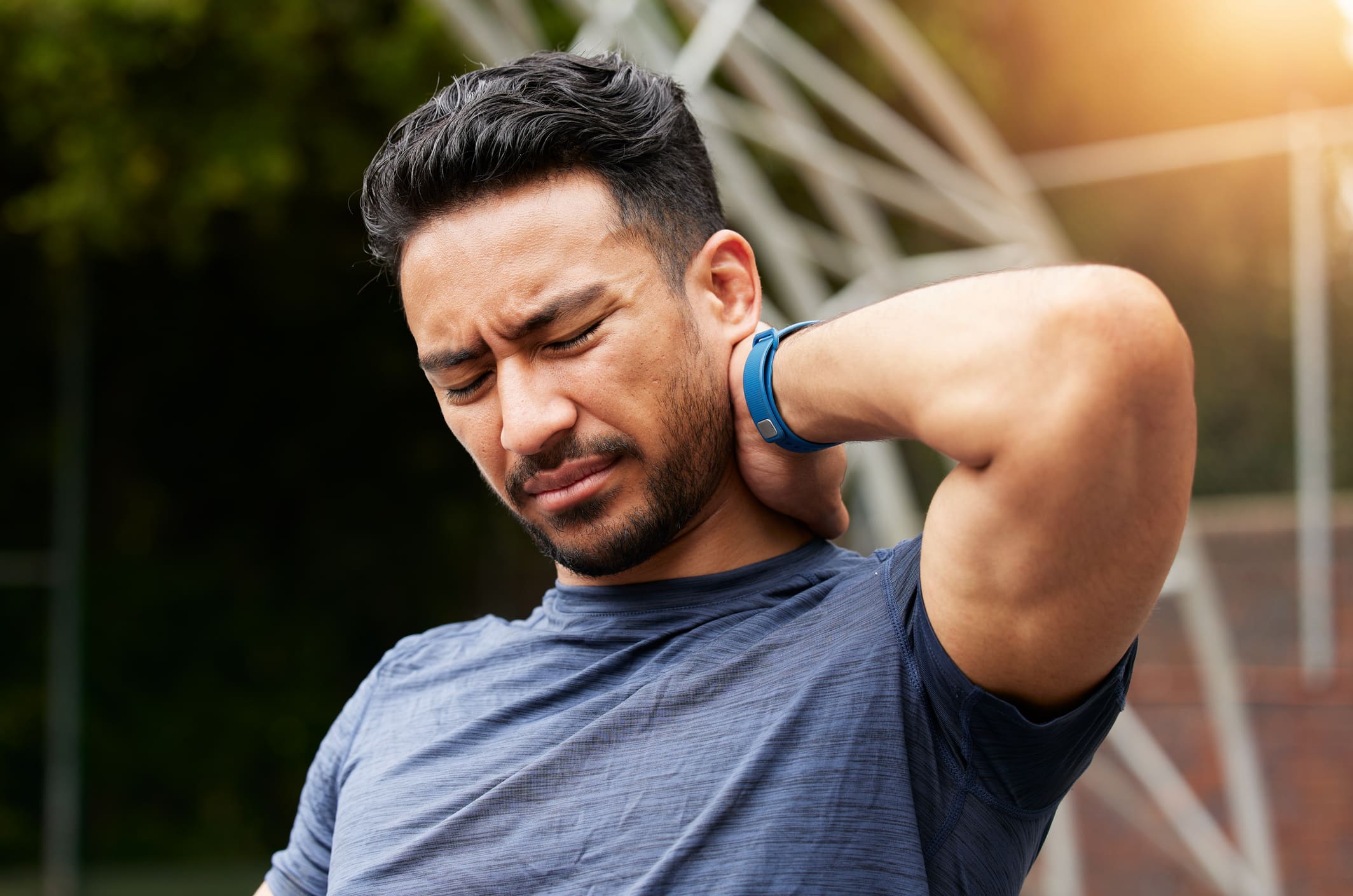 Man experiencing neck pain, a common symptom of cervicalgia, seeking relief at Cavanaugh Chiropractic in Lafayette, Louisiana.