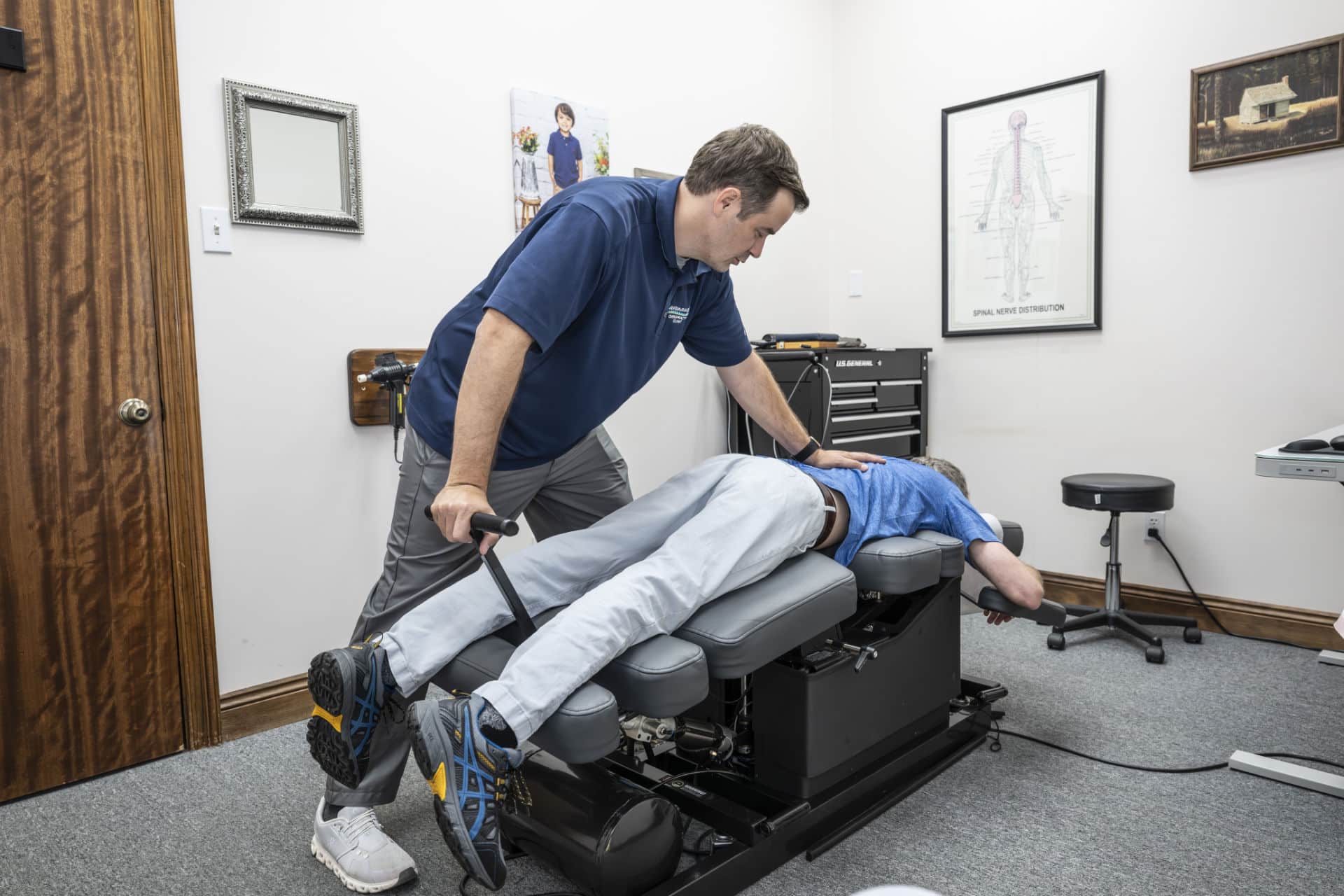 Chiropractor in Lafayette, LA performing Traction Flexion Distraction therapy on a patient