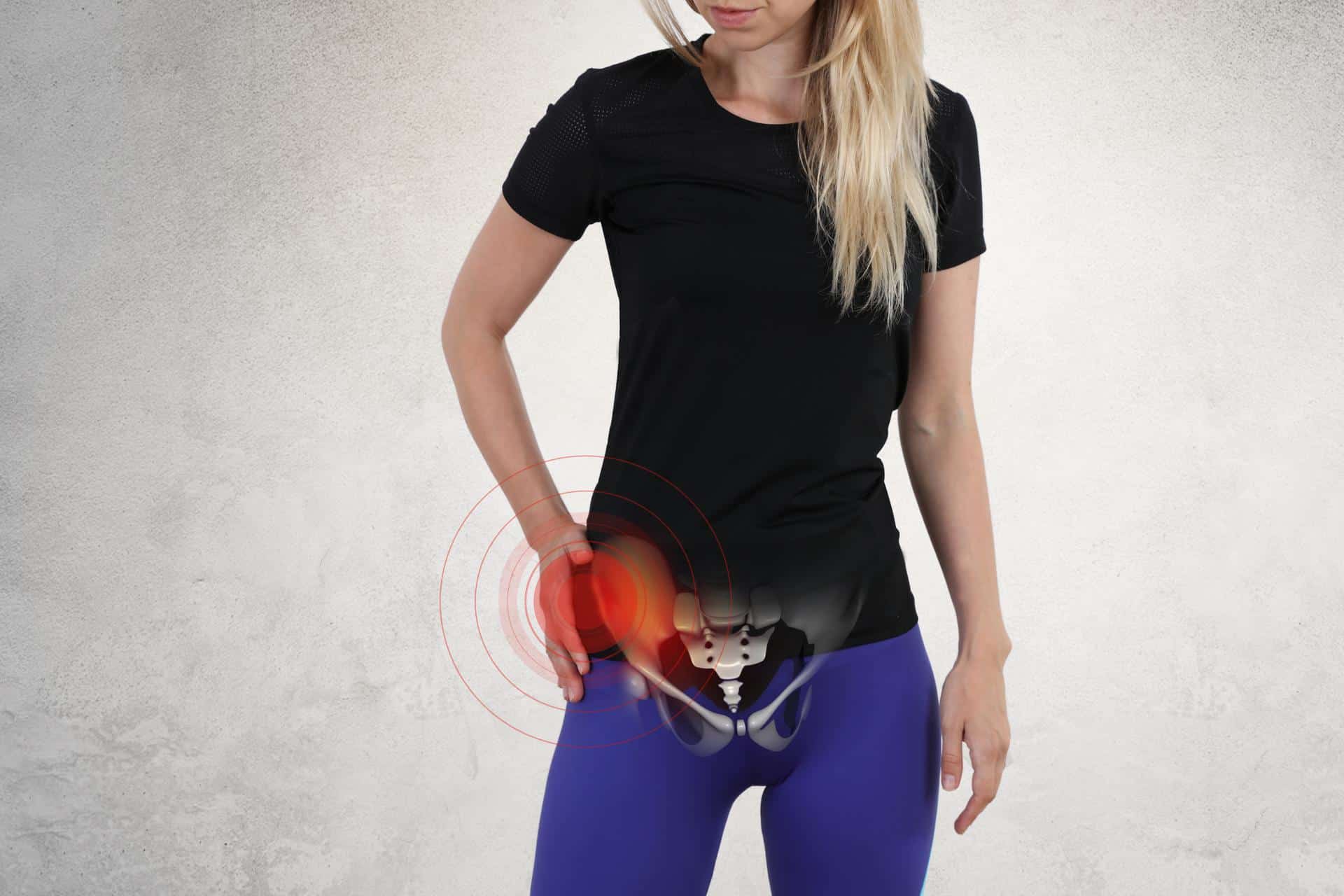 Woman with hip pain from bursitis holding her side in discomfort, representing bursitis relief in Lafayette, LA at Cavanaugh Chiropractic.
