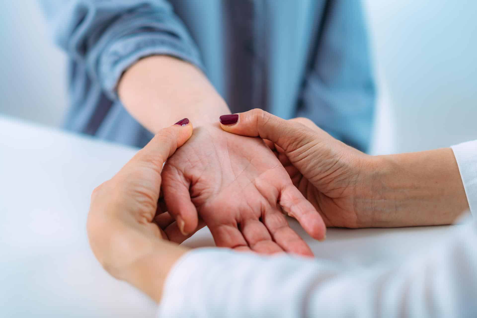 Close-up of a chiropractor evaluating a patient’s hand for carpal tunnel syndrome in Lafayette, Louisiana