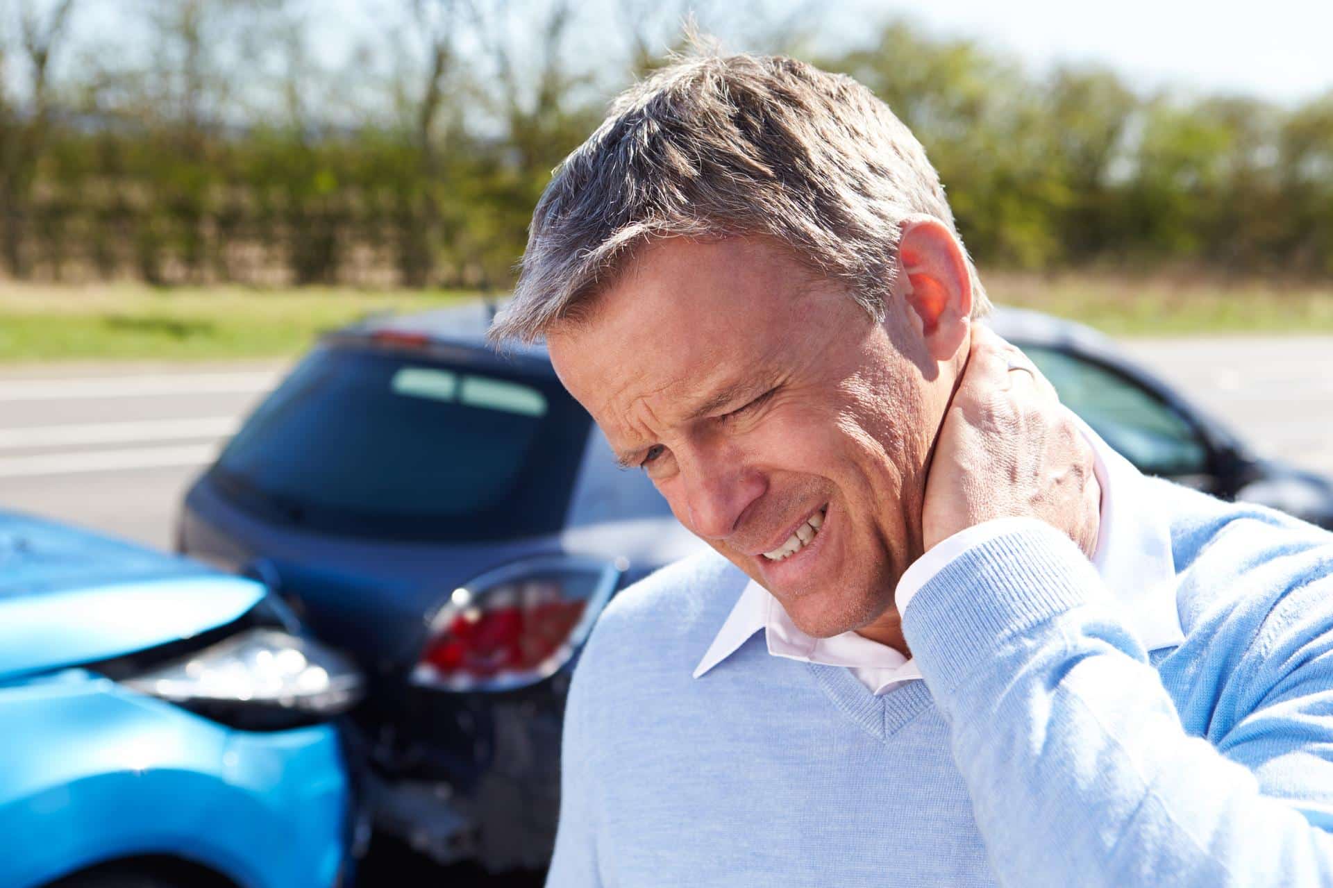 Man holding neck in pain after a car accident, showing signs of whiplash injury, common after rear-end collisions in Lafayette, Louisiana.
